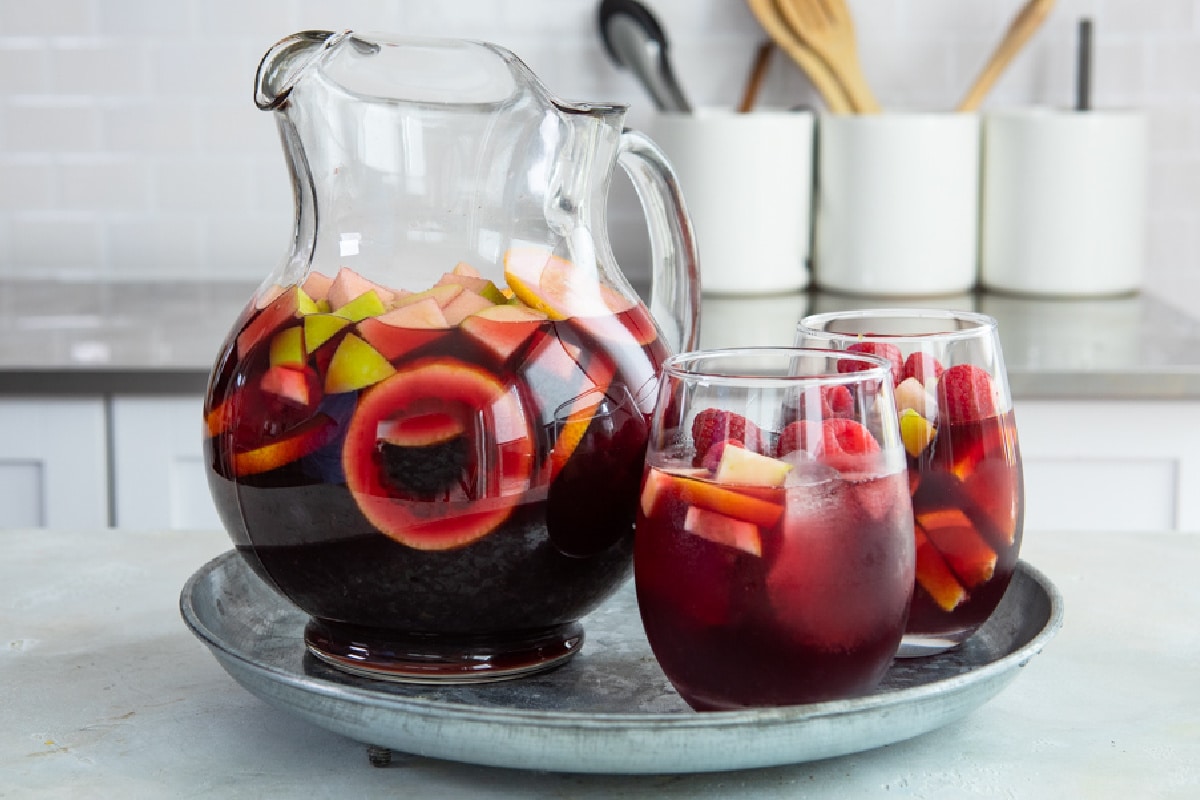 A pitcher and two glasses of red sangria.