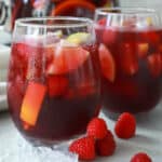A pitcher and two glasses of red sangria.