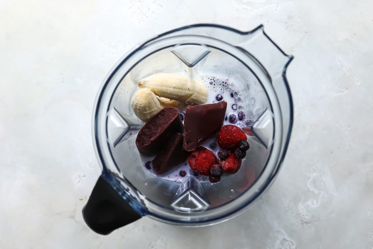 Acai smoothie ingredients in a blender pitcher.