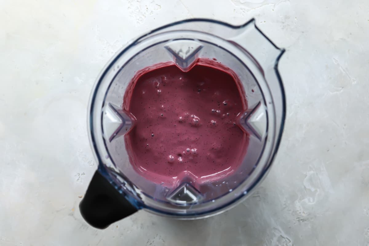 An acai smoothie in a blender pitcher.
