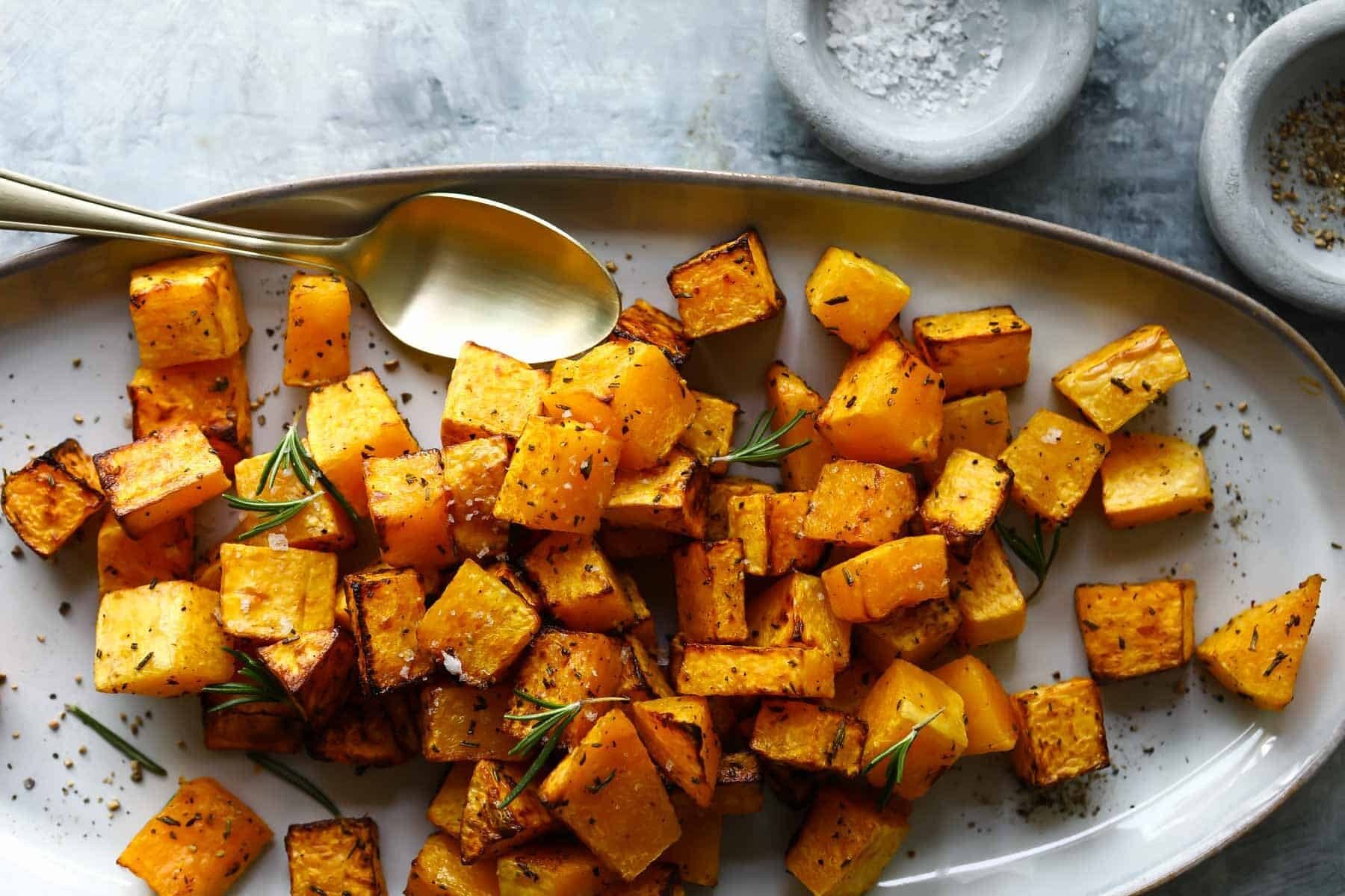An oval platter with air fryer butternut squash on it.
