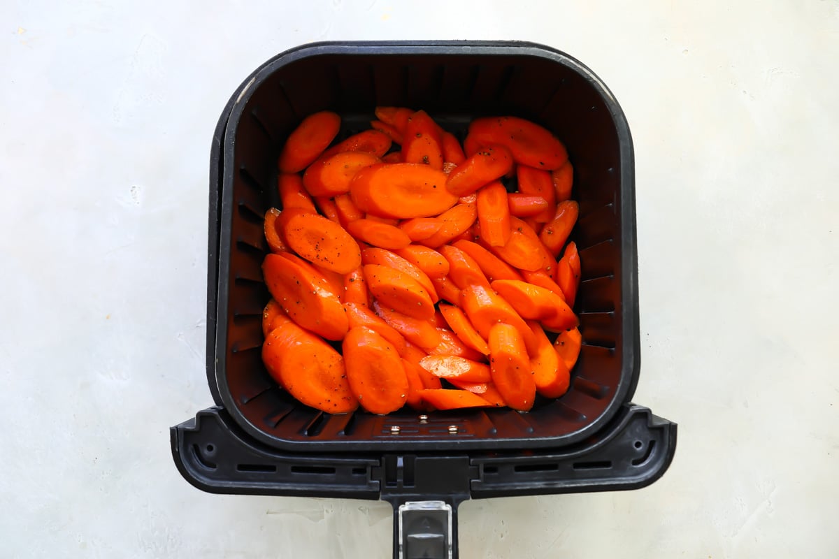 Air fryer carrots in an air fryer basket.