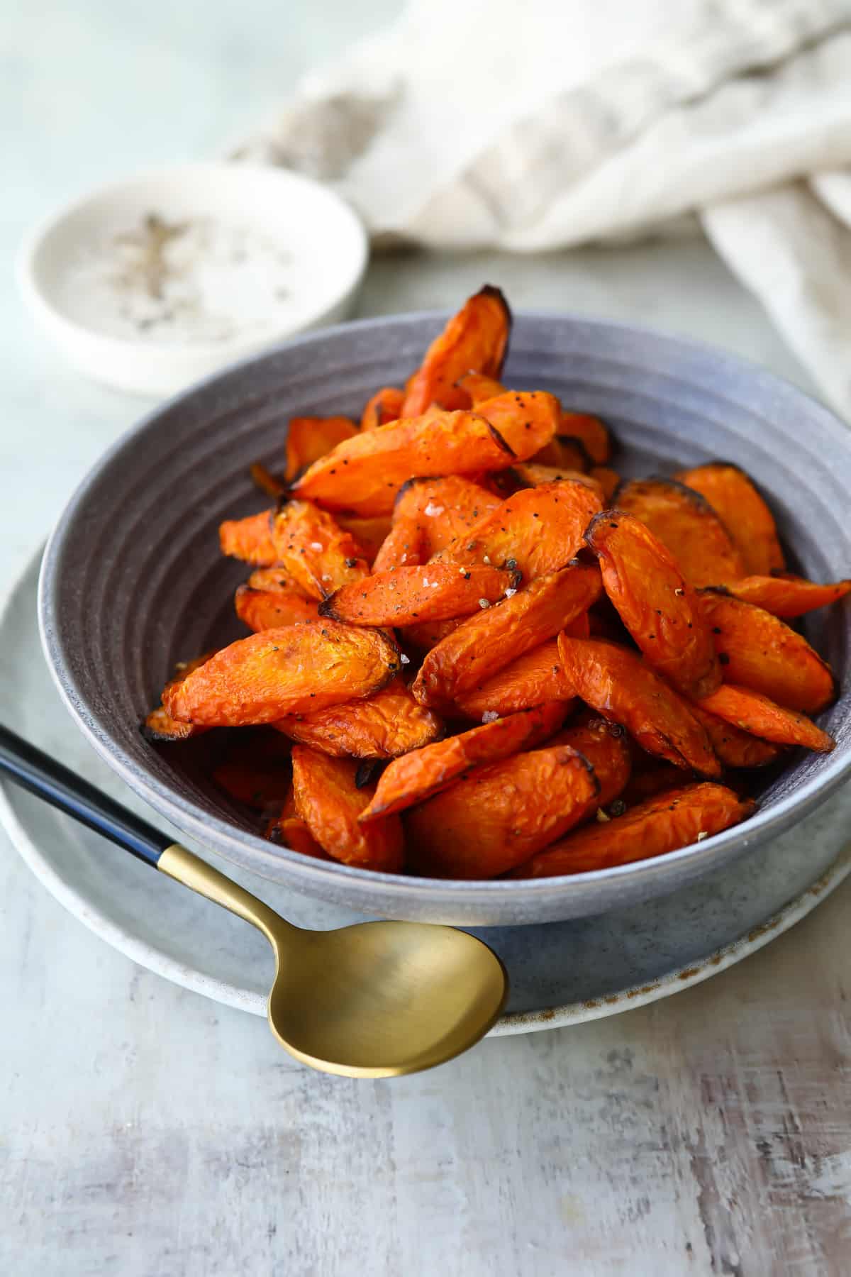 A gray bowl with air fryer carrots.