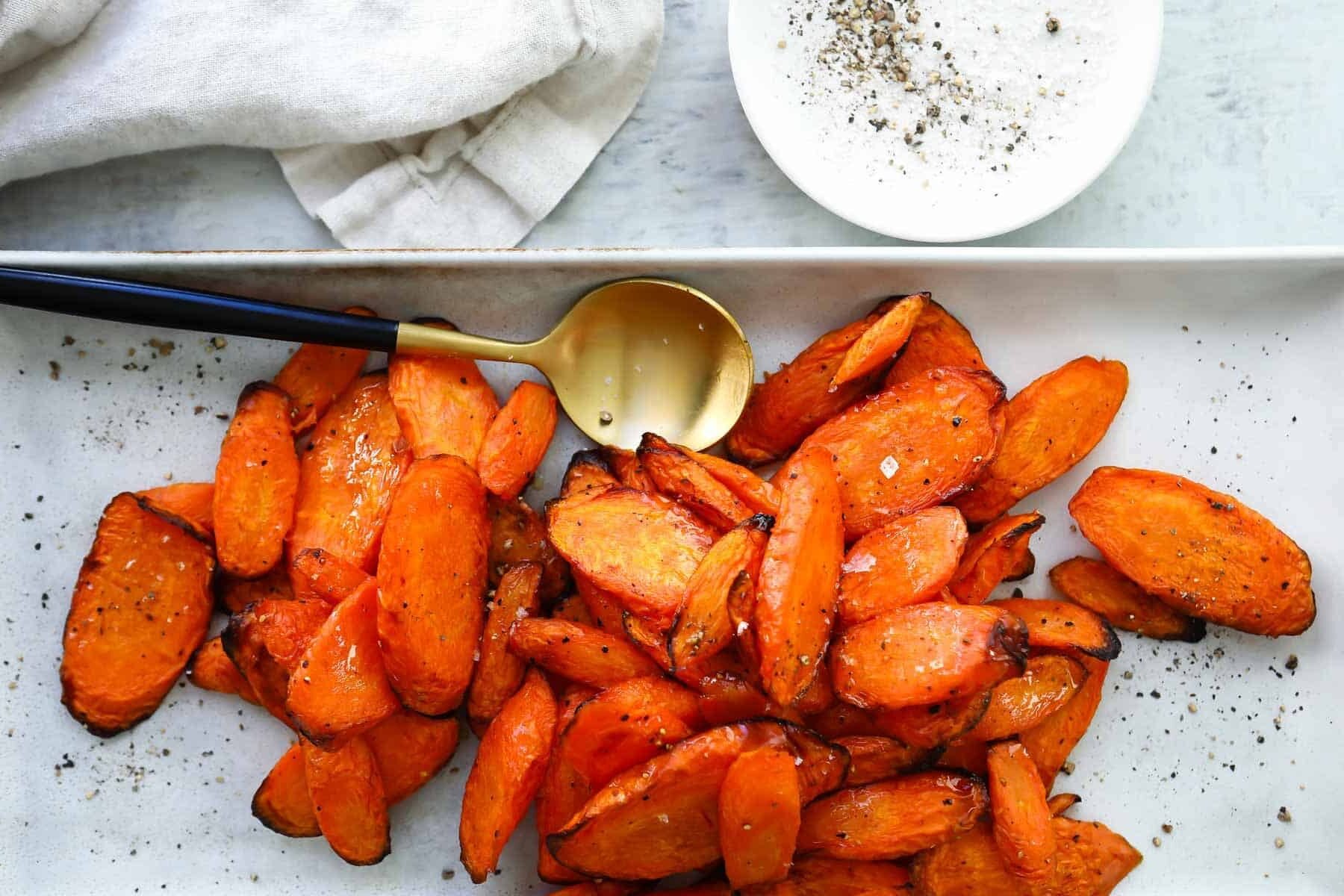 A white serving platter with air fryer carrots.