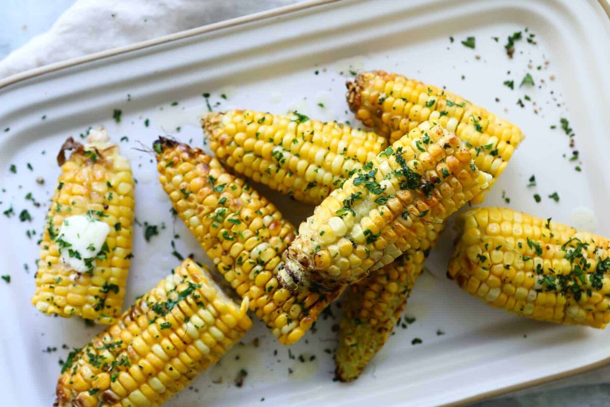 Air fryer corn on the cob halves on a platter.