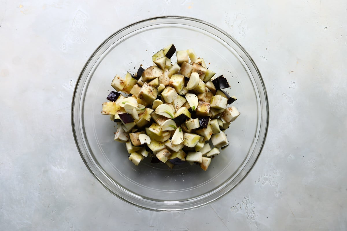A bowl with seasoned eggplant pieces in it.