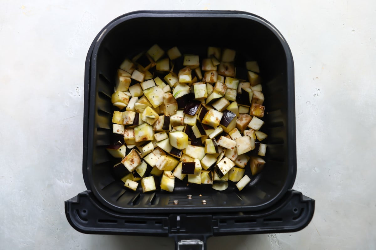 Eggplant in an air fryer basket.