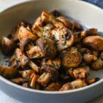Air fryer mushrooms in a gray bowl.