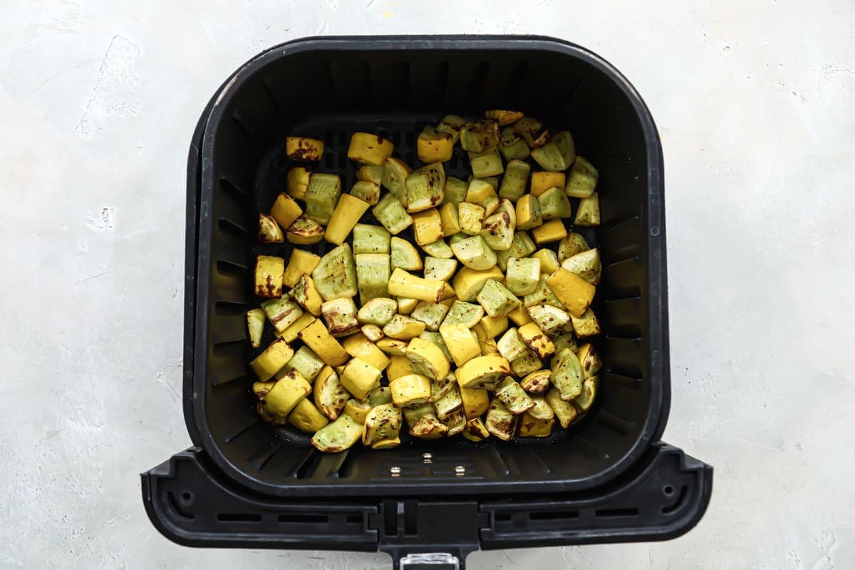 Air fryer squash in an air fryer basket.