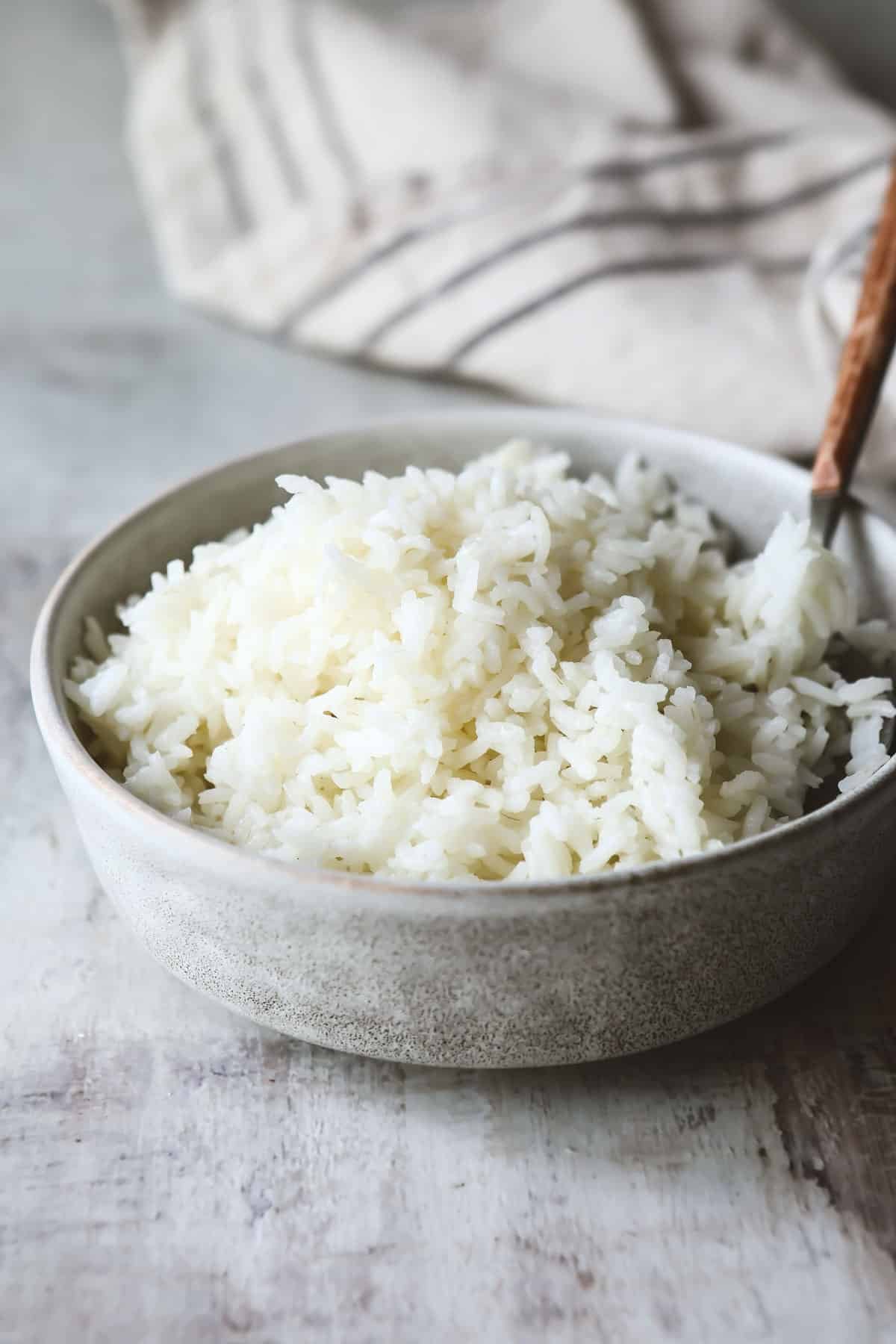 A small gray bowl of baked rice.