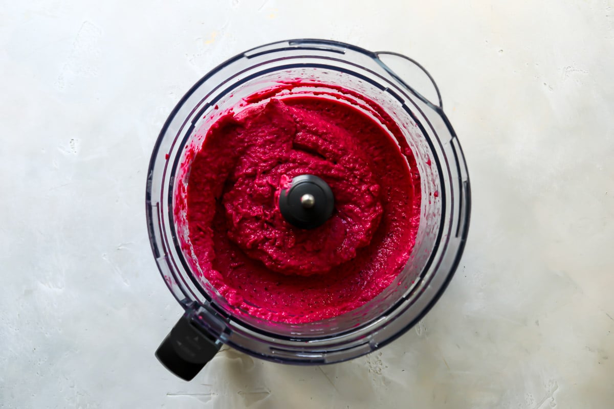Beet hummus being made in a food processor.