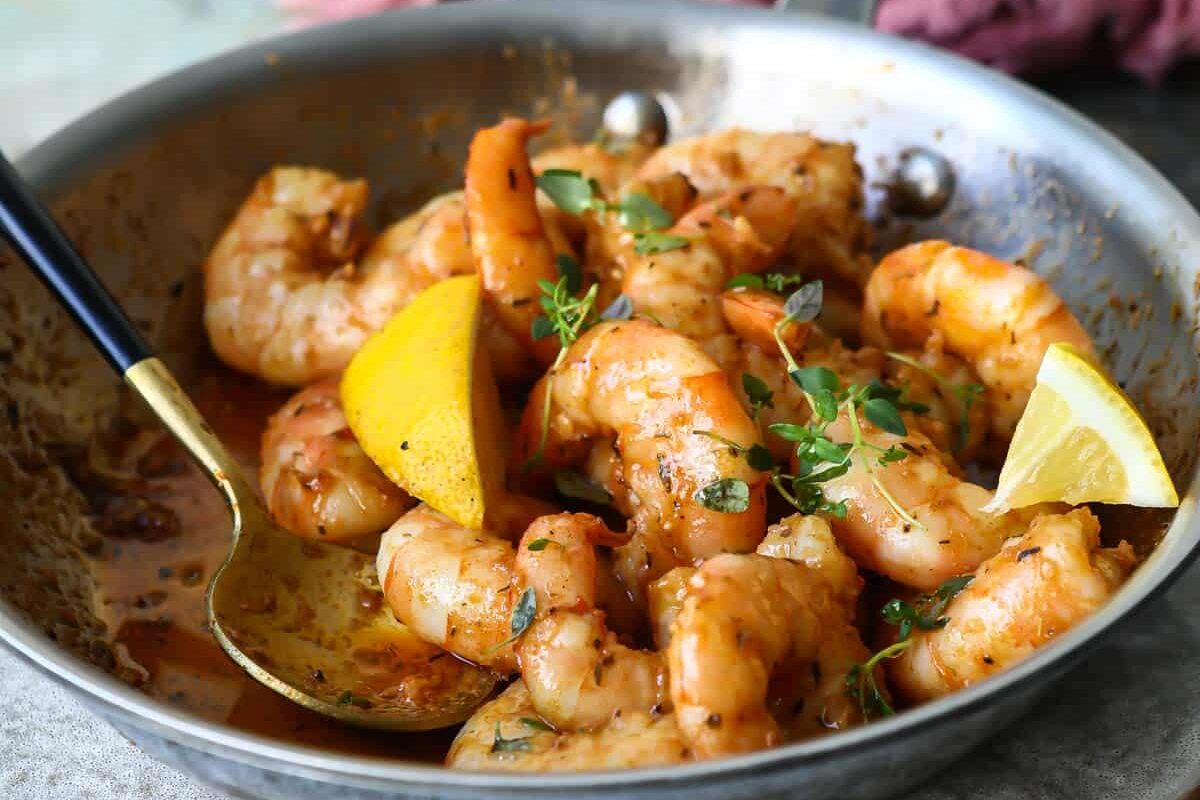 Cajun shrimp in a silver skillet.
