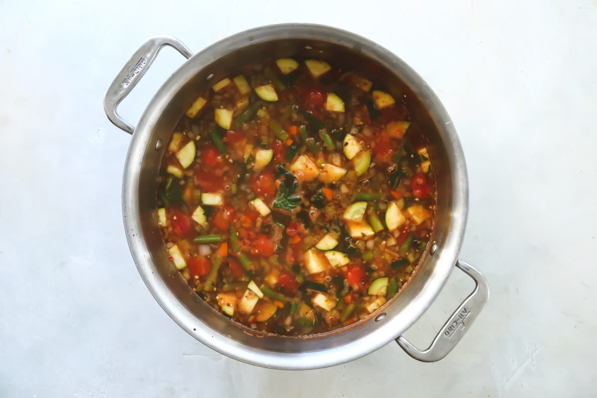 Copycat Olive Garden minestrone in a silver stockpot after simmering.
