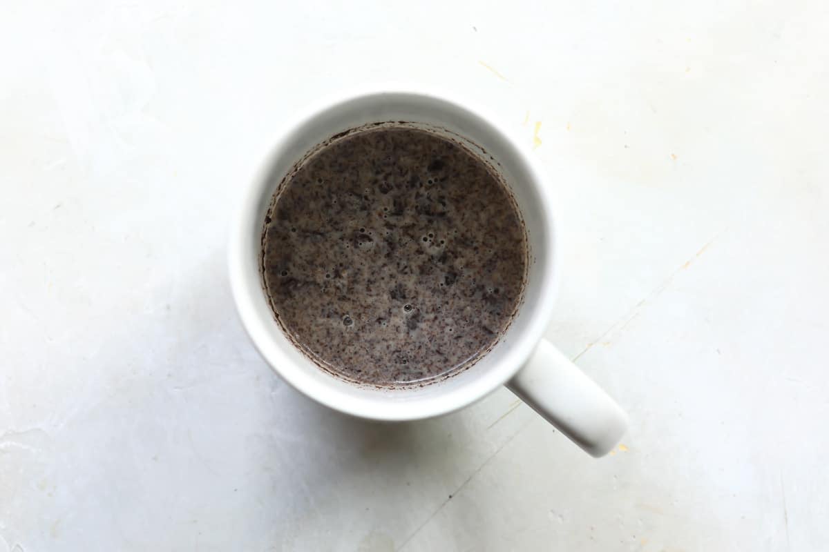 Mashed oreos and milk in a mug.