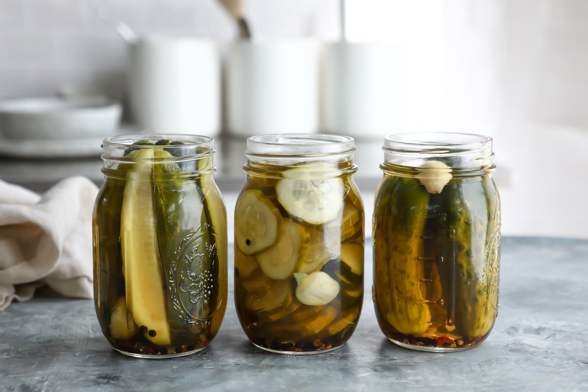Three jars of pickles without lids.