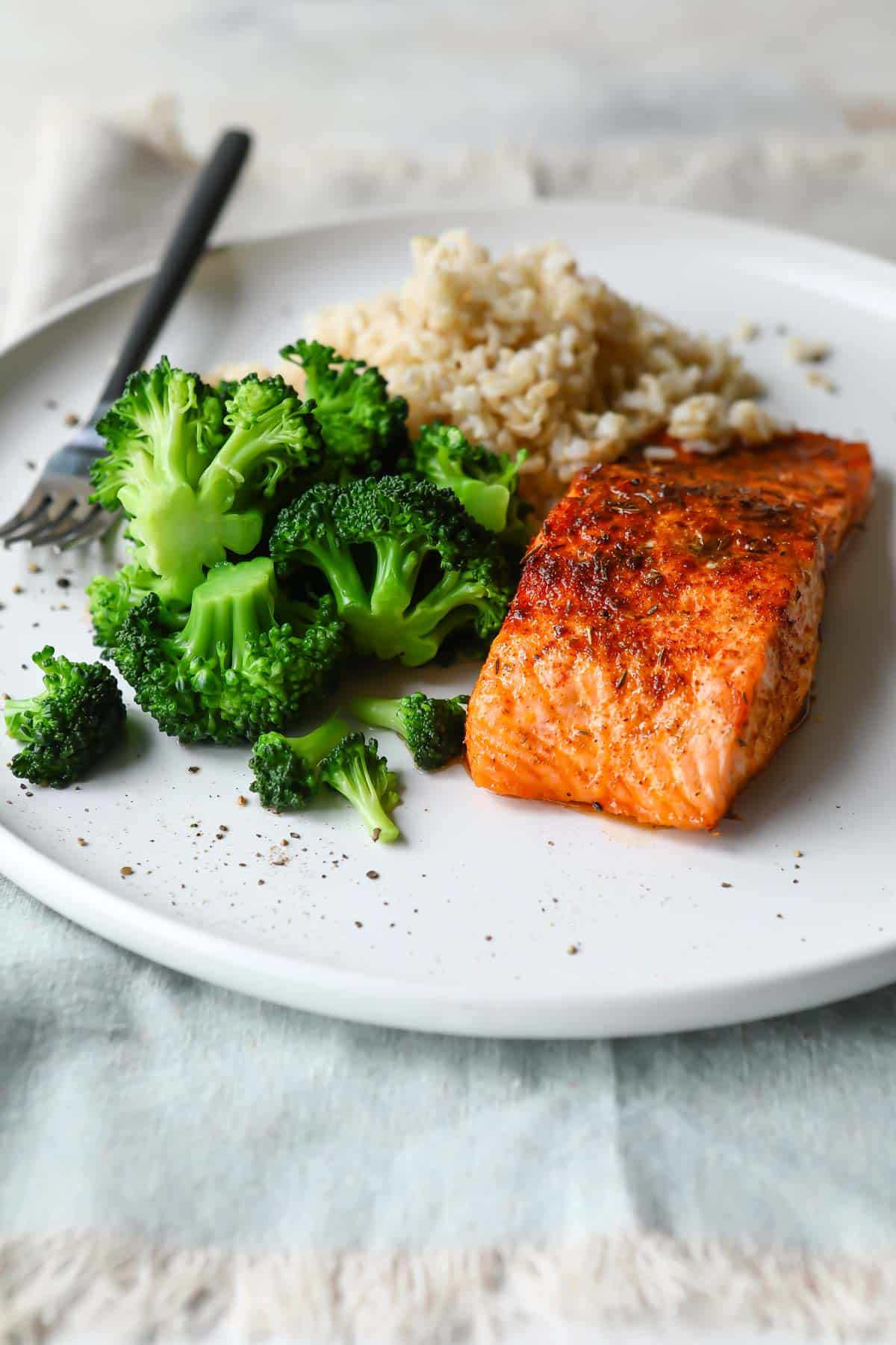 A plate with broccoli, air fryer salmon, and rice.