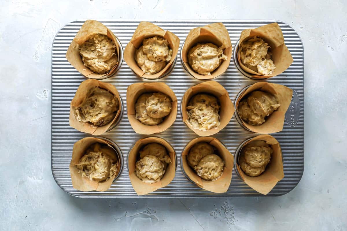 Banana muffins batter in muffin papers before being baked.