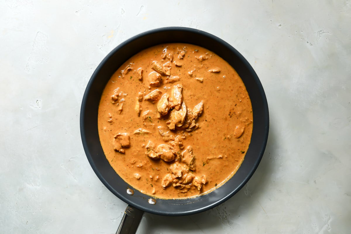 A skillet of butter chicken.