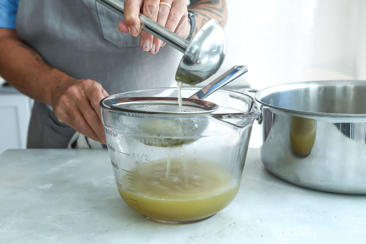 Straining chicken broth for chicken tortilla soup.