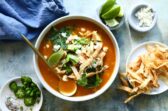 Bowls of chicken tortilla soup with all the garnishes.