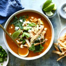 Bowls of chicken tortilla soup with all the garnishes.