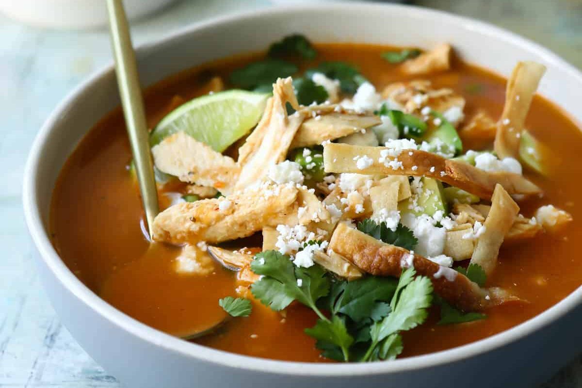 Bowls of chicken tortilla soup with all the garnishes.