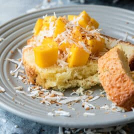 Coconut cake with mango cubes on top.