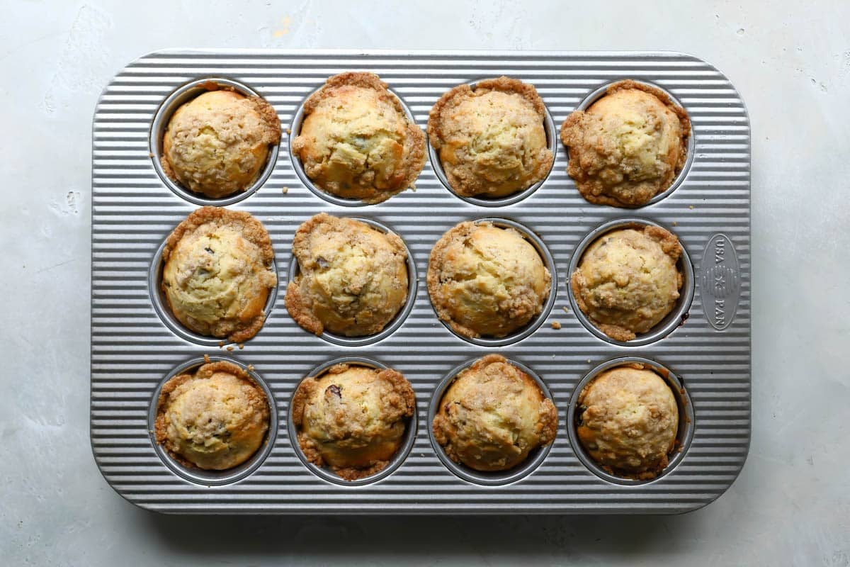 A muffin pan filled with cranberry orange muffins.