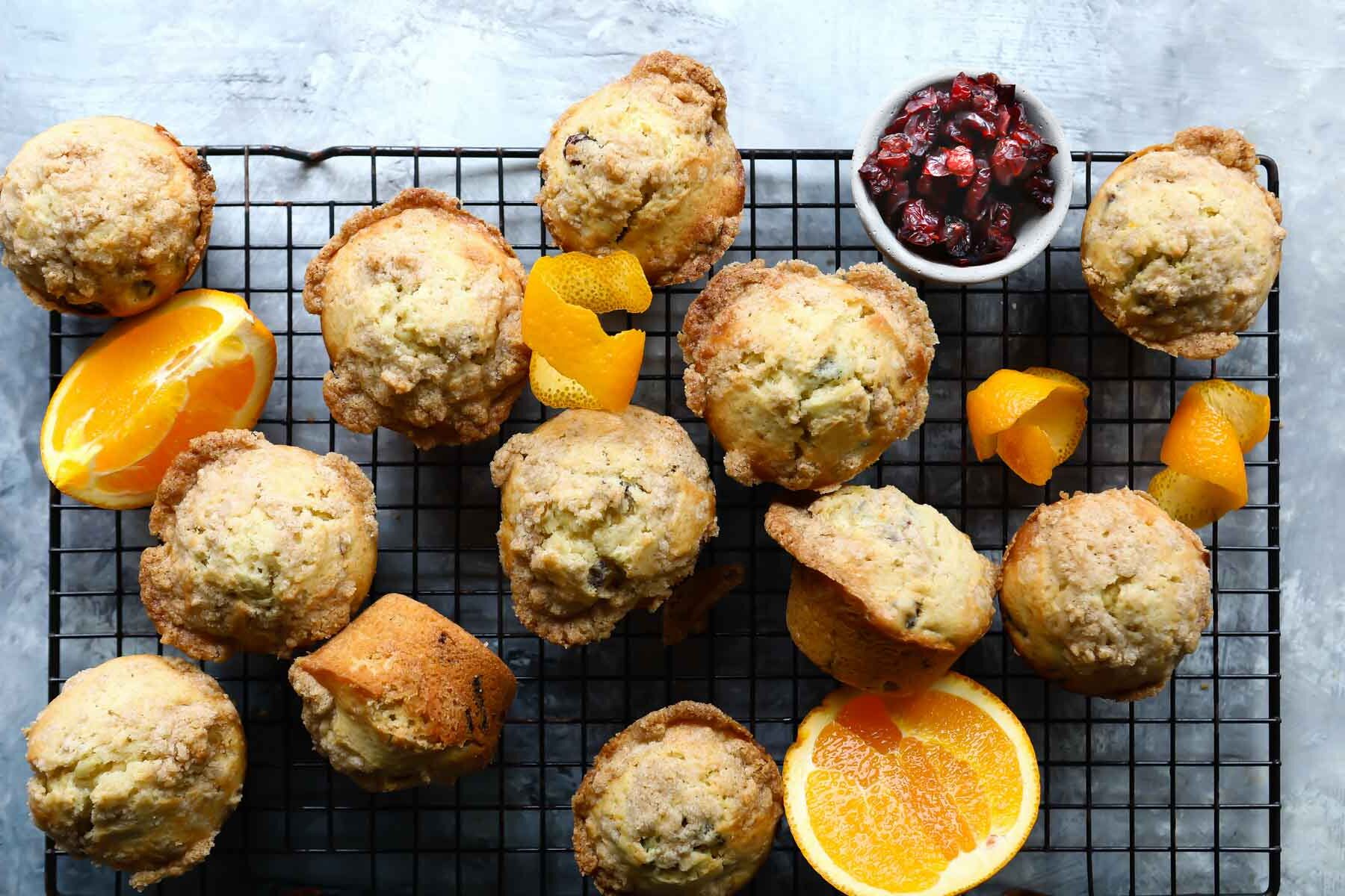 A stack of cranberry orange muffins on a cooling rack.