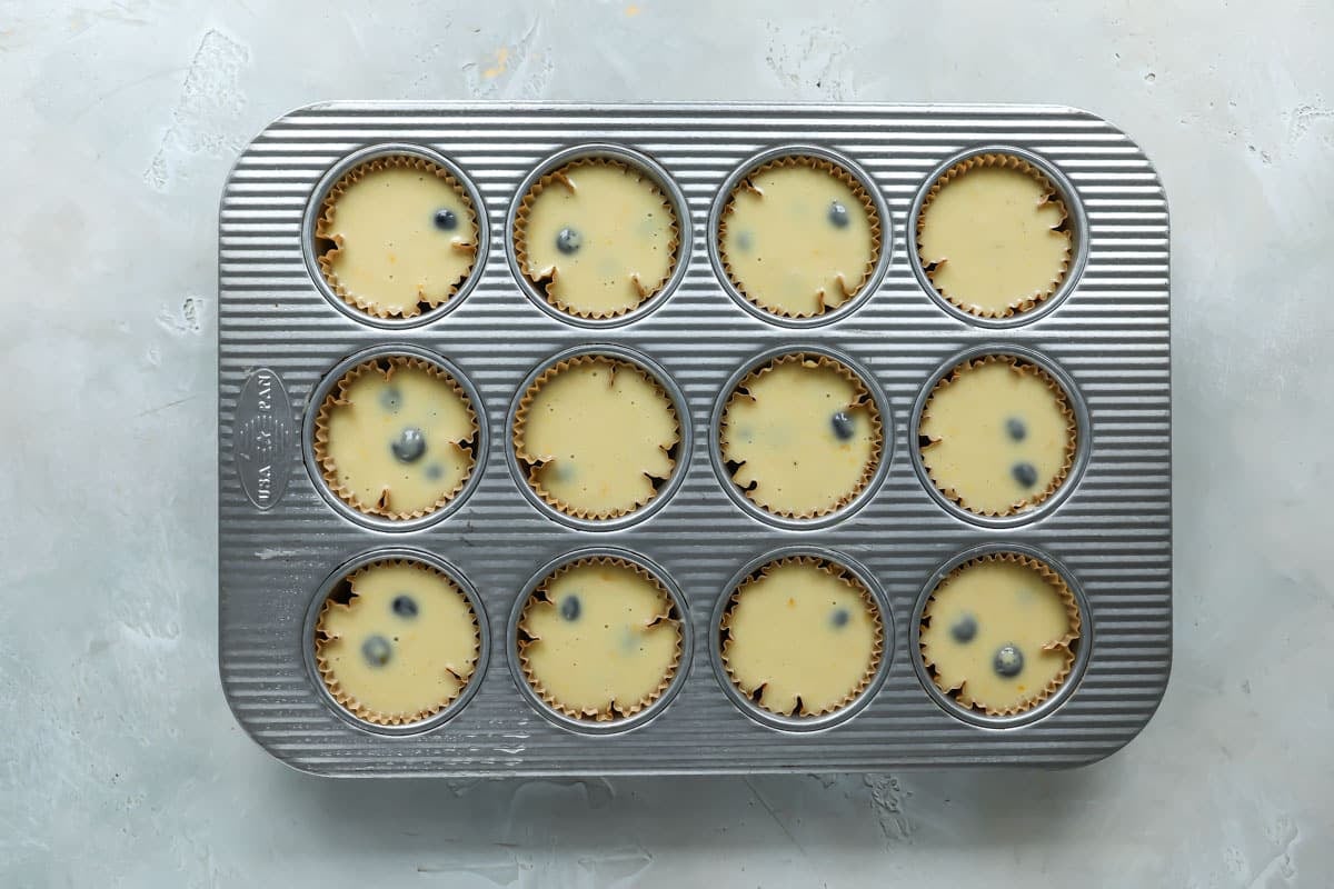 Muffin batter in a muffin pan.