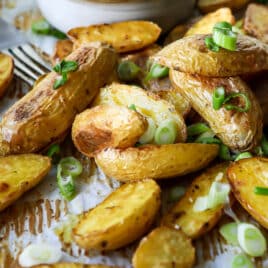 Roasted fingerling potatoes on a baking sheet.