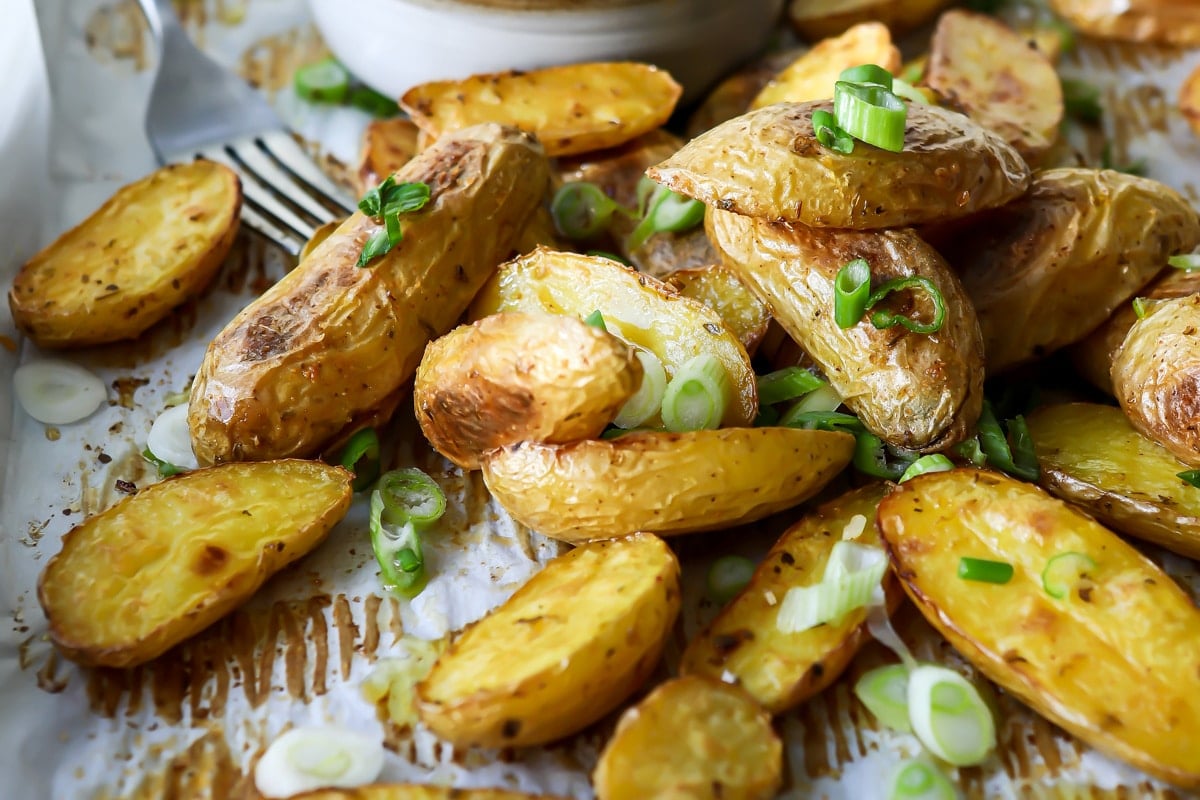 Roasted fingerling potatoes on a baking sheet.