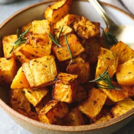 Air fryer butternut squash in a brown bowl.