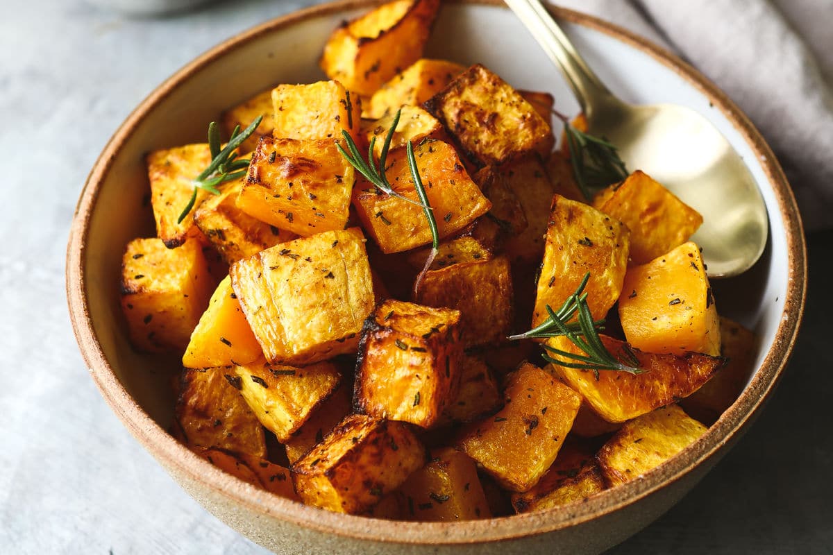 Air fryer butternut squash in a brown bowl.