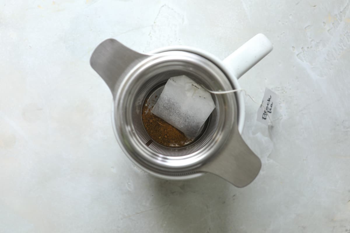 Steeping masala chai with a gold timer nearby.