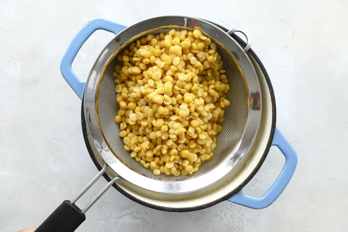 Straining chana dal (split chickpeas).