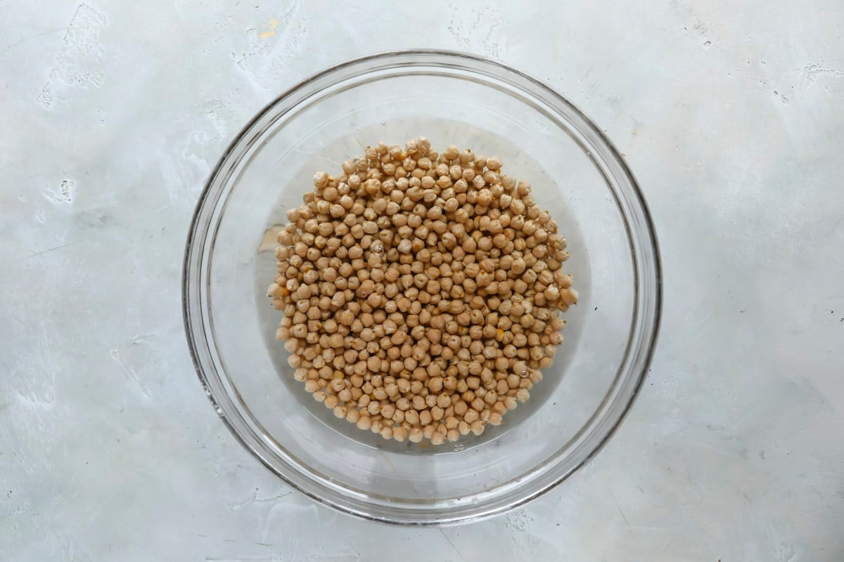 Soaking chickpeas in water and baking soda.