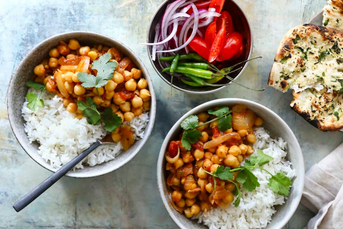 Bowls of chana masala with rice.
