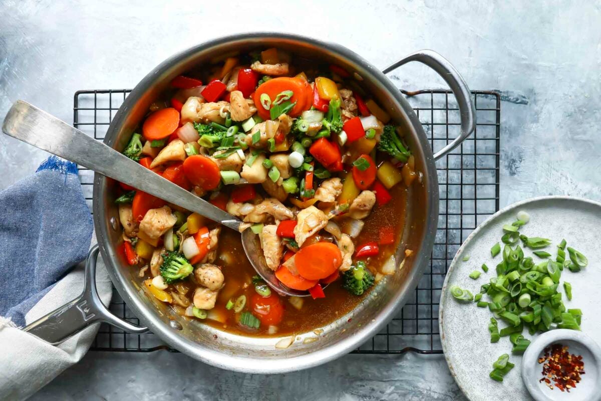 A skillet full of chicken stir fry.