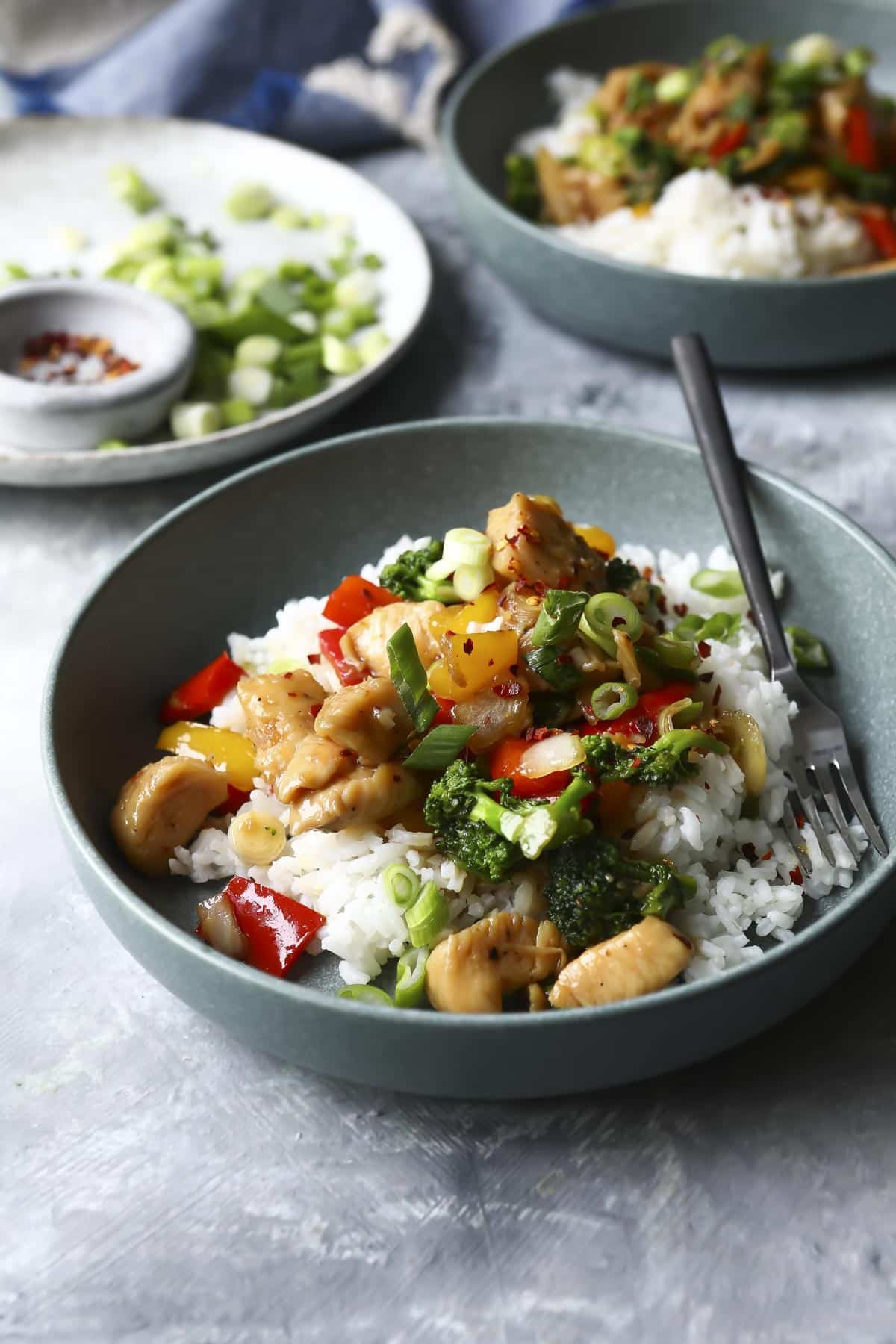 A bowl of homemade chicken stir fry with white rice.