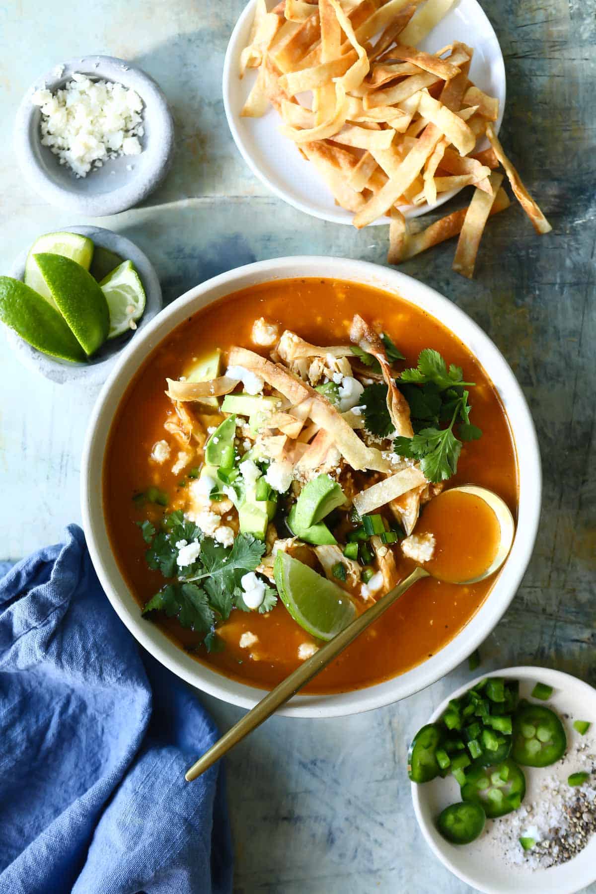 Bowls of chicken tortilla soup with all the garnishes.