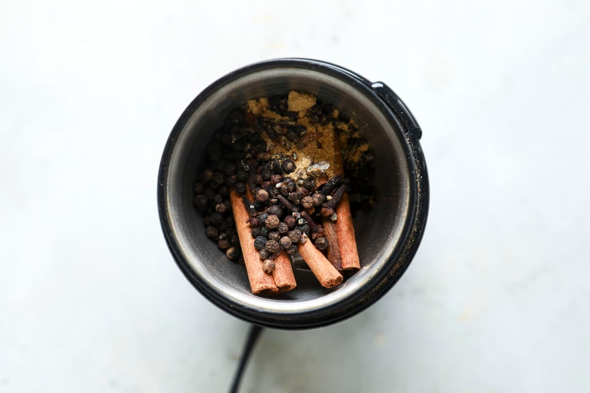 Grinding whole spices for garam masala.