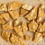 A silicone mat full of shards of peanut brittle.