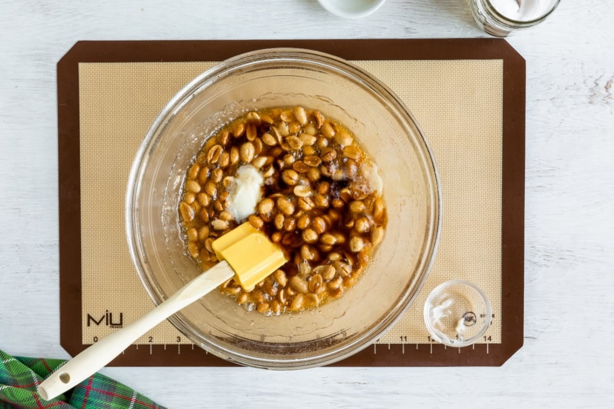 A bowl of sugar and corn syrup with microwave peanuts.