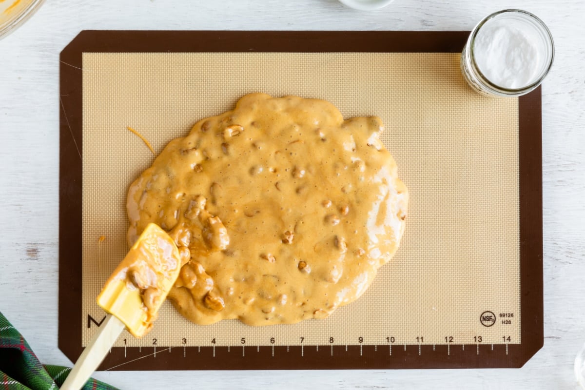 Peanut brittle batter on a silicone mat before cooling.
