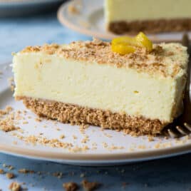 A slice of no bake lemon cheesecake on a small plate.