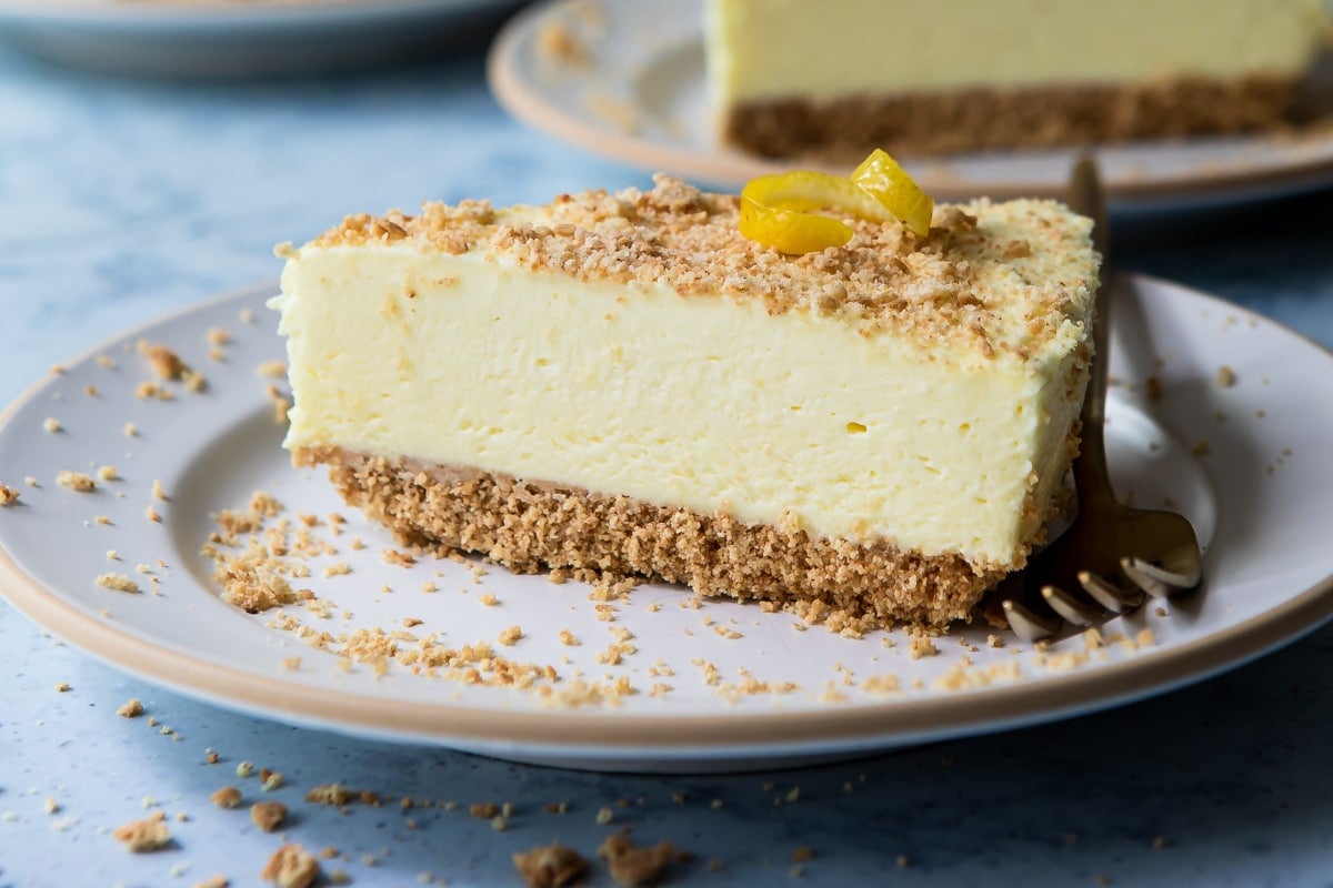 A slice of no bake lemon cheesecake on a small plate.