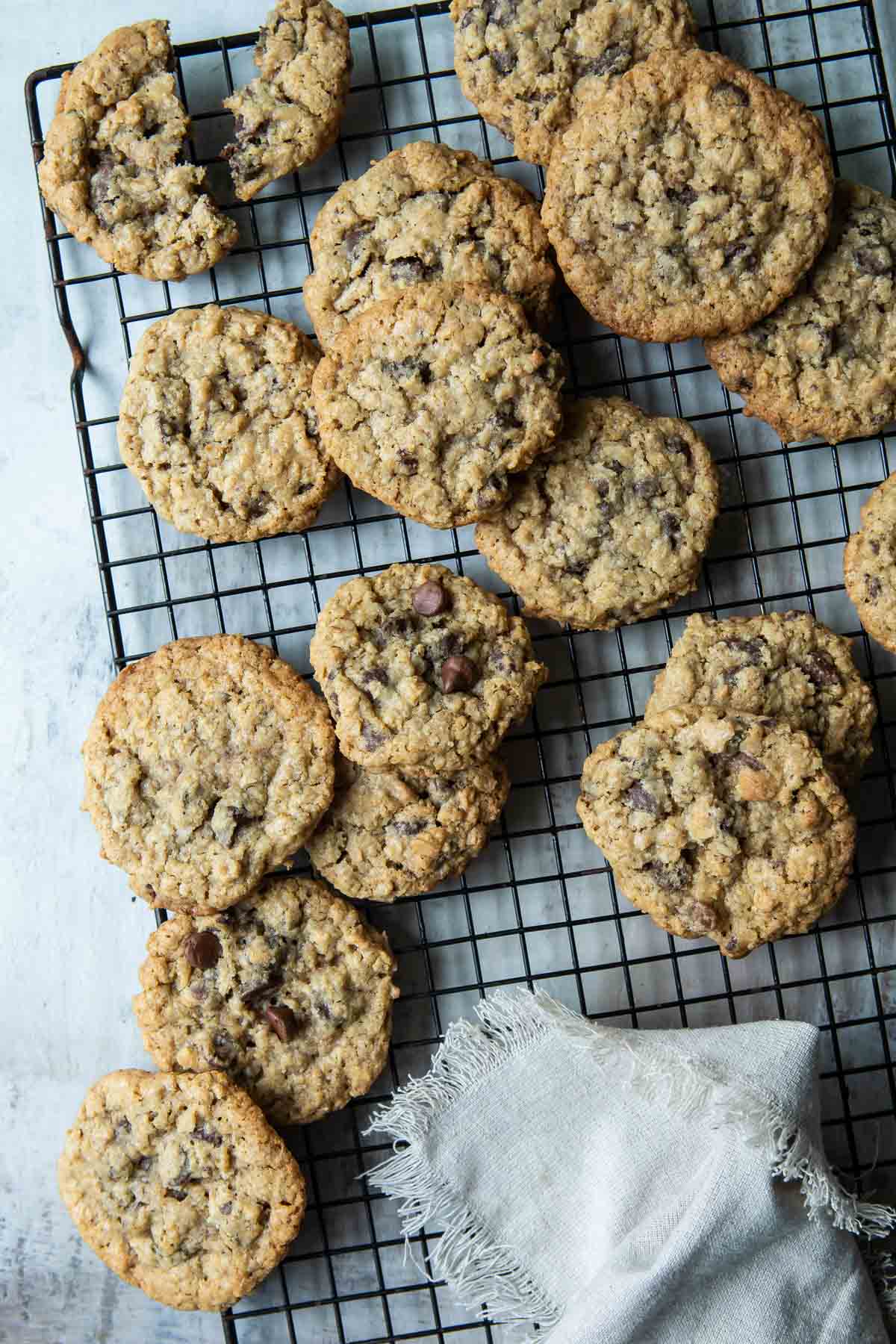 Oatmeal chocolate chip cookies on a cooling rack.