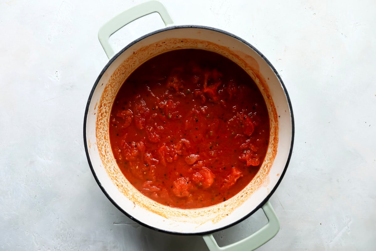 Tomatoes and seasonings in a pot for potato curry.