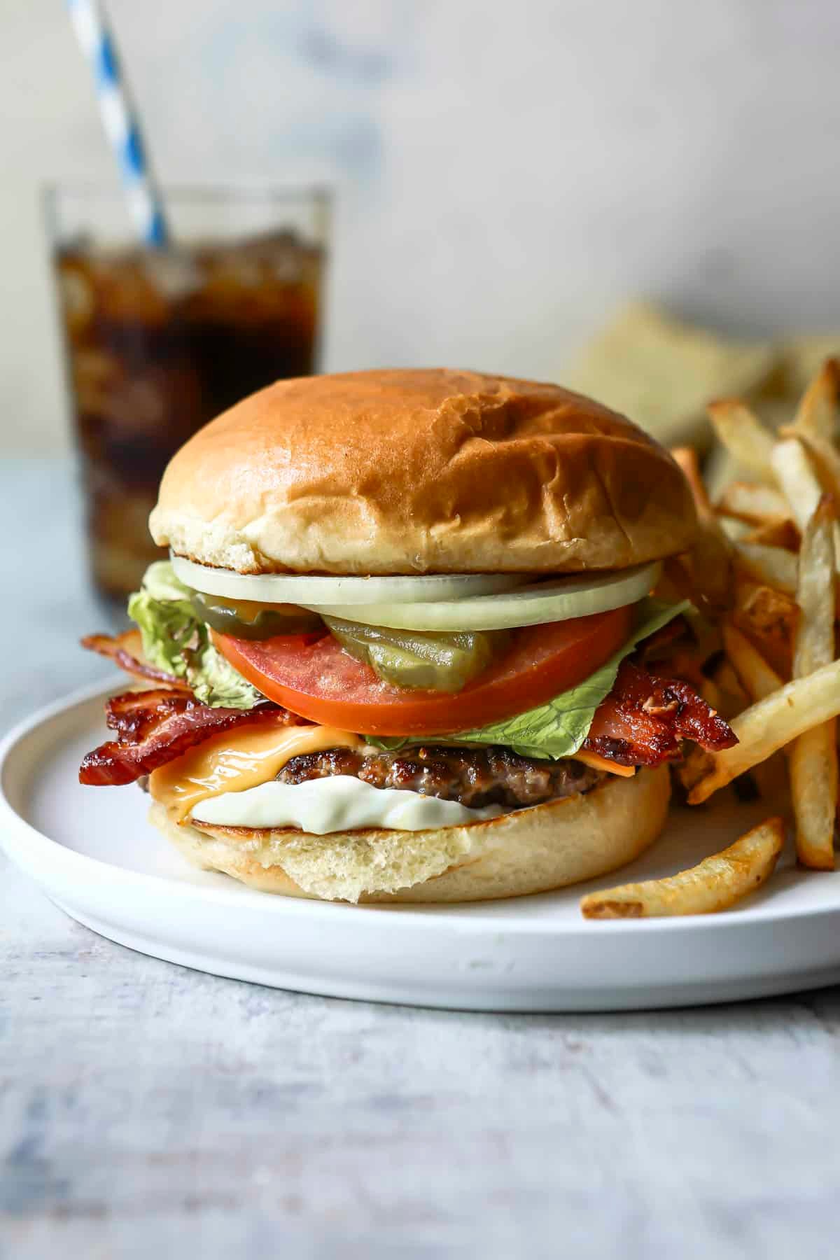 A bacon cheeseburger with french fries.